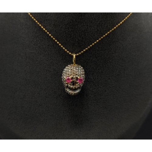 35 - A RUBY AND DIAMOND SET SKULL PENDANT NECKLACE, silver gilt frame, fitted on a silver-gilt chain, 45c... 