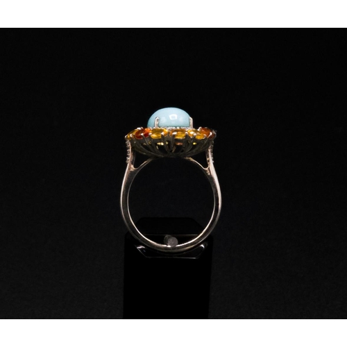 37 - A TURQUOISE AND FANCY COLOURED SAPPHIRE SET DRESS RING, the central cabouchon surrounded by diamonds... 