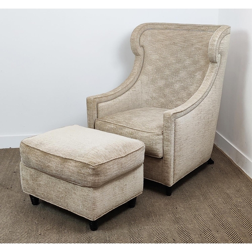 419 - ARMCHAIR, of curved form 78cm x 112cm H with studded detail and a footstool to match. (2)