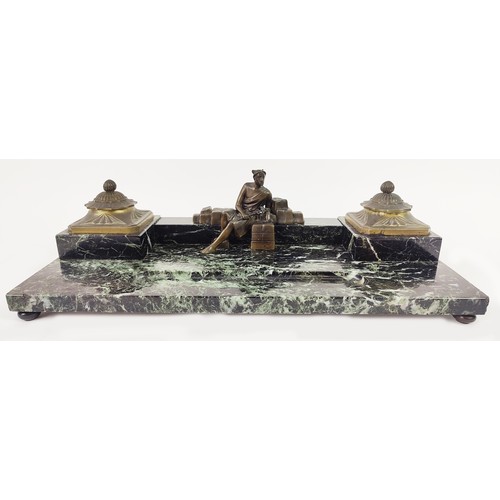 46 - AN ART DECO MARBLE AND BRONZE DESK SET, with two ink wells, and a central figure, with an inset pen ... 