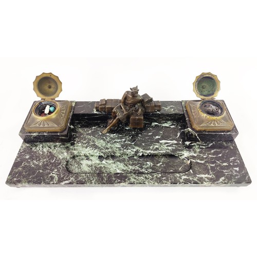 46 - AN ART DECO MARBLE AND BRONZE DESK SET, with two ink wells, and a central figure, with an inset pen ... 