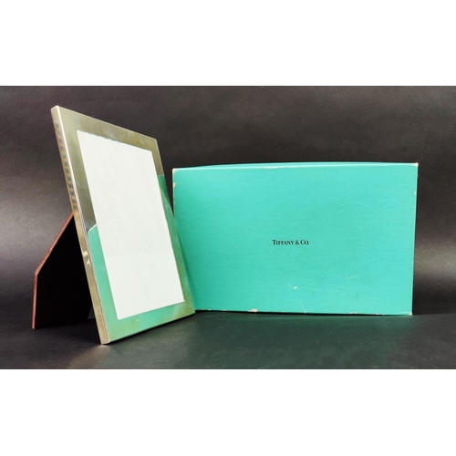 60 - A TIFFANY & CO. STERLING SILVER PHOTOFRAME, 18cm high, 13cm wide, complete with original box and pou... 