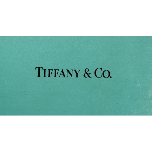 60 - A TIFFANY & CO. STERLING SILVER PHOTOFRAME, 18cm high, 13cm wide, complete with original box and pou... 