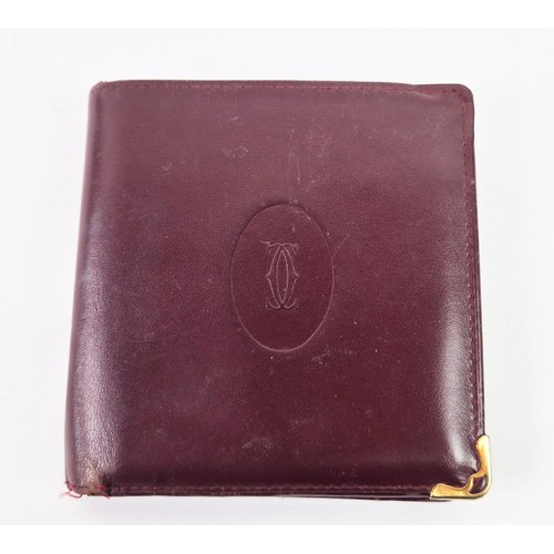 27A - CARTIER WALLET, iconic burgundy colour leather with matching fabric monogram lining, gold tone hardw... 