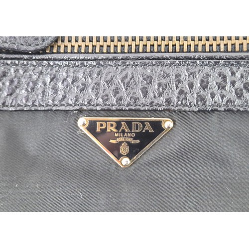 4A - PRADA NYLON BAG, with leather handles and trims, front and back zippered pockets and a further back ... 