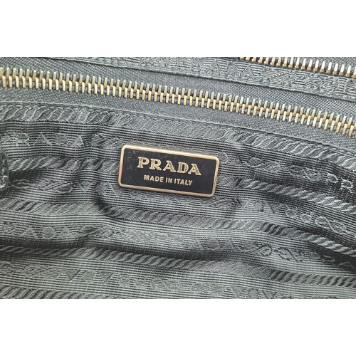 4A - PRADA NYLON BAG, with leather handles and trims, front and back zippered pockets and a further back ... 