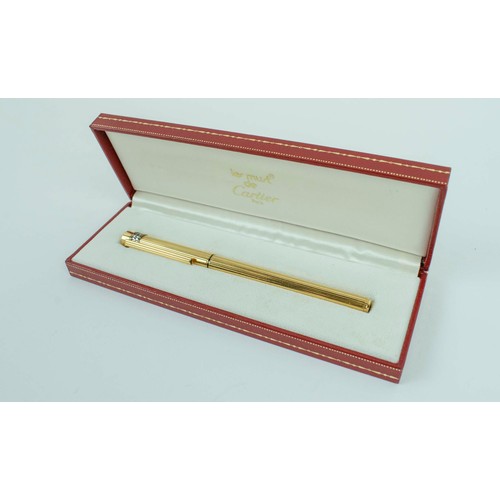 55 - A CARTIER GOLD PLATED BALLPOINT PEN, 1989, serial number 717560, Must De Cartier, complete with orig... 