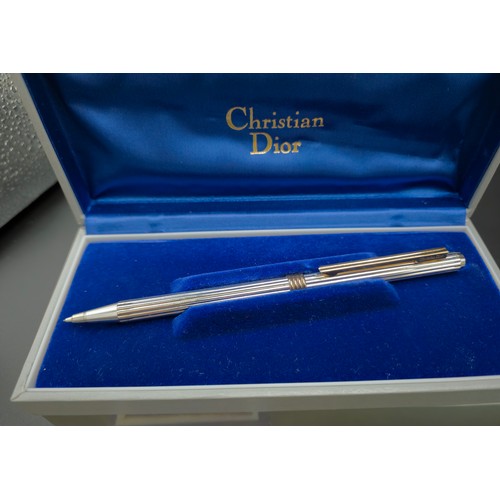 58 - A TIFFANY & CO SILVER BALLPOINT PEN, with an extra replaceable cartridge, a Christian Dior pencil, a... 