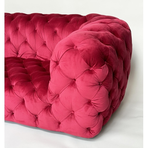 467 - SOFA, scarlet velvet all over deep button upholstered with rounded arms, 195cm W.