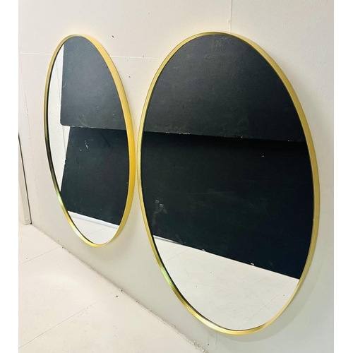 368 - OVAL WALL MIRRORS, a pair, gilt metal frames, 110cm x 75cm.