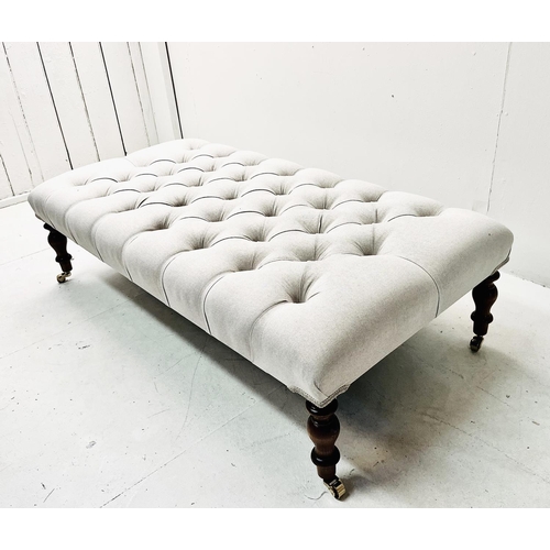 502 - FOOTSTOOL, with deep buttoned neutral linen upholstery on turned supports, 32cm H 121cm W x 62cm D.