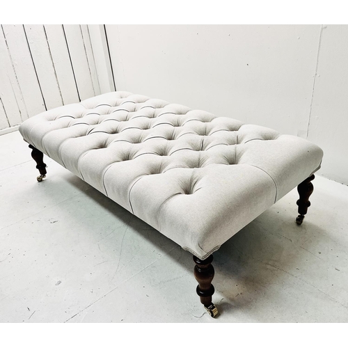 502 - FOOTSTOOL, with deep buttoned neutral linen upholstery on turned supports, 32cm H 121cm W x 62cm D.