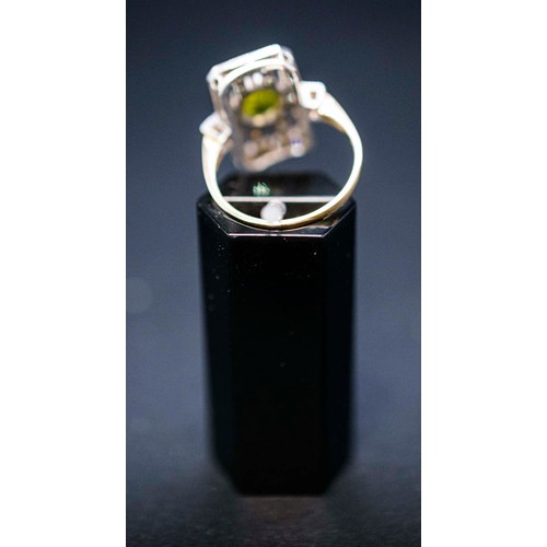 47 - ART DECO STYLE PERIDOT AND DIAMOND SET COCKTAIL RING, the peridot of approximately 0.85 carats, surr... 