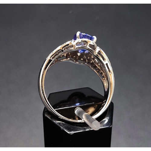 57 - PLATINUM TANZANITE AND DIAMOND SET DRESS RING, the oval tanzanite of approximately 1.52 carats, surr... 