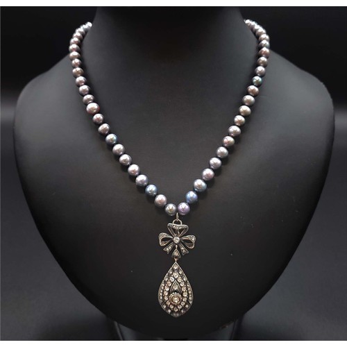 60 - GREY CULTURED PEARL NECKLACE, diamond set bow and tear drop pendant, the diamonds of approximately 1... 