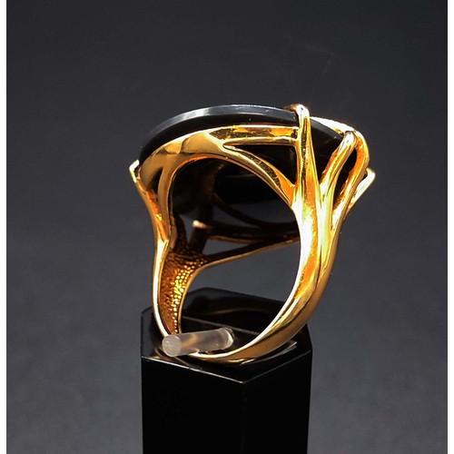 62 - 18CT GOLD ONYX CABOCHON DRESS RING, with an overlaid web pattern, ring size P½, complete with box