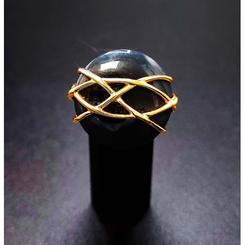 62 - 18CT GOLD ONYX CABOCHON DRESS RING, with an overlaid web pattern, ring size P½, complete with box