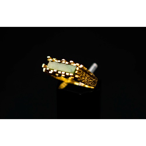 33 - 9CT GOLD AND JADE RING, hallmarked 'AJ Ld', London 1973, of abstract textured design with rectangula... 