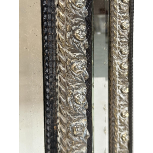 262 - DUTCH WALL MIRROR, 19th century rectangular ebony and repoussé silvered metal, with cushion shaped m... 