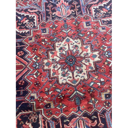 116 - ANTIQUE PERSIAN HERIZ CARPET, 310cm x 230cm.