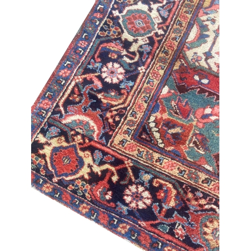 116 - ANTIQUE PERSIAN HERIZ CARPET, 310cm x 230cm.