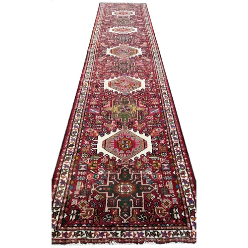 119 - FINE MID 20th CENTURY PERSIAN HERIZ KARAJA RUNNER, 337cm x 85cm.