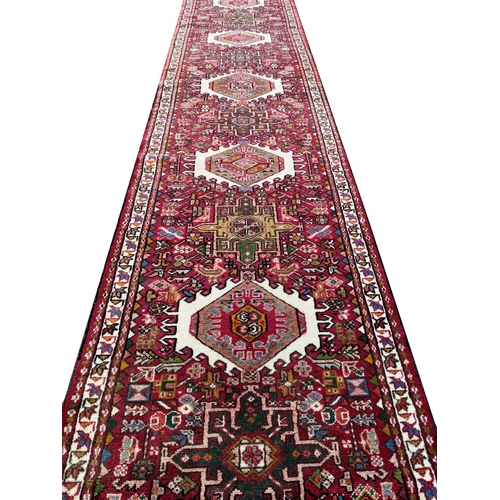 119 - FINE MID 20th CENTURY PERSIAN HERIZ KARAJA RUNNER, 337cm x 85cm.