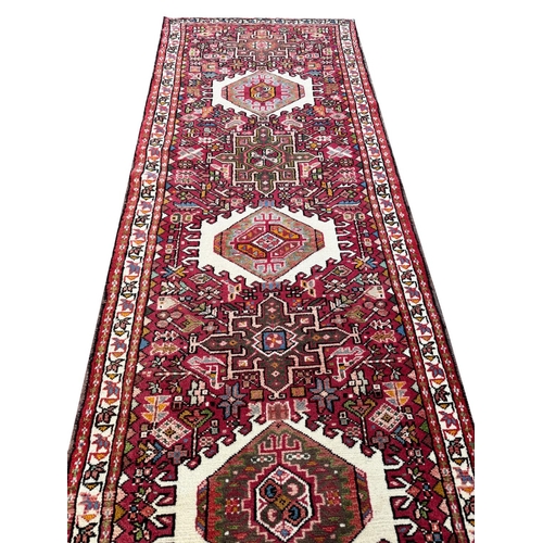 119 - FINE MID 20th CENTURY PERSIAN HERIZ KARAJA RUNNER, 337cm x 85cm.