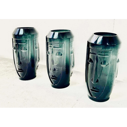 422 - VASES, a set of three, glass with stylised face design, 34cm x 17cm x 17cm. (3)