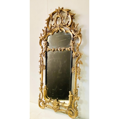 424 - WALL MIRROR, Chippendale Rococo style with scrolling gilt metal frame, 155cm x 72cm.