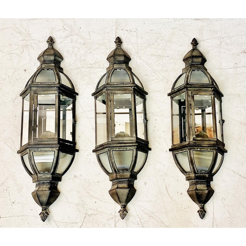 435 - WALL LANTERNS, a set of three, Regency style with mirrored backs in verdigris finish, 72cm H x 22cm ... 