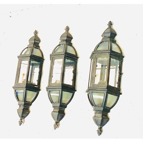 435 - WALL LANTERNS, a set of three, Regency style with mirrored backs in verdigris finish, 72cm H x 22cm ... 