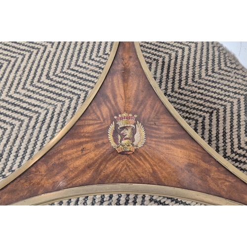 220 - SIDE TABLE, the circular top on brass support, with heraldic crest to undertier, 46cm W x 71cm H.