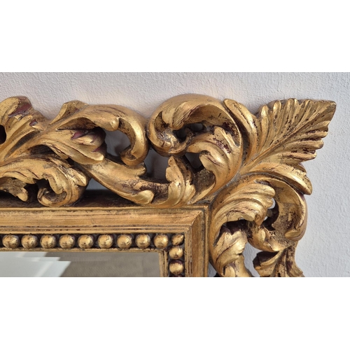 224 - WALL MIRROR, with a decorative gilt frame and a bevelled plate, 77cm x 98cm.