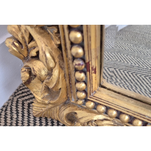 224 - WALL MIRROR, with a decorative gilt frame and a bevelled plate, 77cm x 98cm.