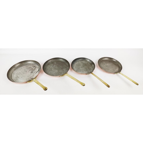 25 - BATTERIE DE CUISINE, four graduated copper frying pans. (4)