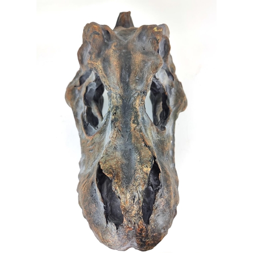 309 - CONTEMPORARY SCHOOL SCULPTURE, of a T Rex skull, painted resin, 38cm H x 52cm L.