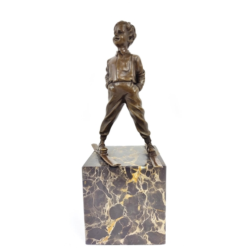 330 - AFTER JOHANN FERDINAND PREISS, of a skier in bronze on a marble base, 39cm H.