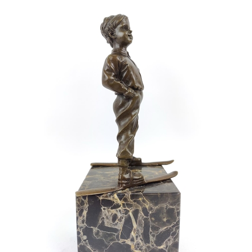 330 - AFTER JOHANN FERDINAND PREISS, of a skier in bronze on a marble base, 39cm H.