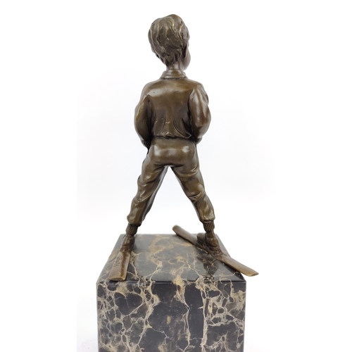 330 - AFTER JOHANN FERDINAND PREISS, of a skier in bronze on a marble base, 39cm H.