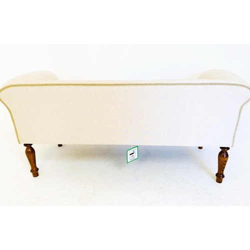 477 - SOFA, with neutral linen upholstery on turned wooden supports, 54cm x 140cm x 64cm.