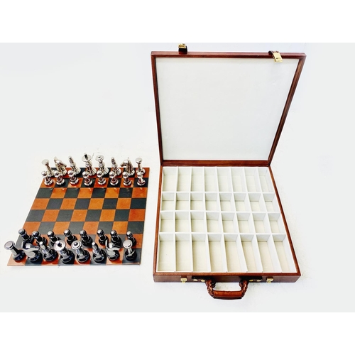 491 - TRAVELLING CHESS SET, in a leather4d case, 30cm x 30cm x 6cm H.