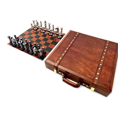 491 - TRAVELLING CHESS SET, in a leather4d case, 30cm x 30cm x 6cm H.