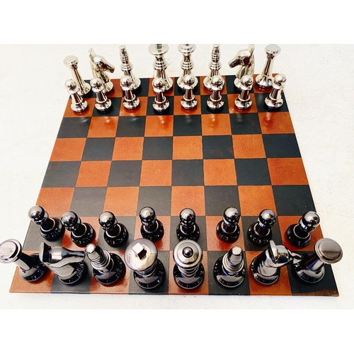 491 - TRAVELLING CHESS SET, in a leather4d case, 30cm x 30cm x 6cm H.