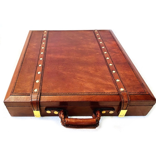 491 - TRAVELLING CHESS SET, in a leather4d case, 30cm x 30cm x 6cm H.