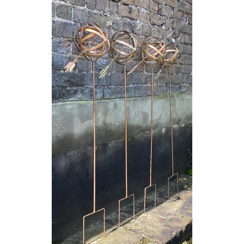 499 - ARMILLARY SHPERE GARDEN STAKES, a set of four, copper coloured metal, 115cm H x 40cm x 17cm. (4)