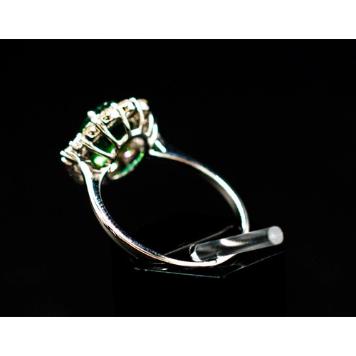 30 - 18CT WHITE GOLD RING SET, with an oval-cut emerald surrounded by a halo of diamonds, emerald 1.38ct,... 