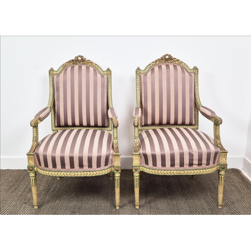 176 - FAUTEUILS, a pair, late 19th century French parcel gilt, cream and green painted with mauve striped ... 