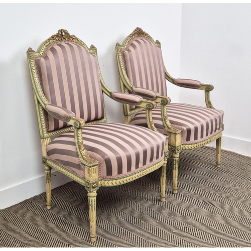 176 - FAUTEUILS, a pair, late 19th century French parcel gilt, cream and green painted with mauve striped ... 