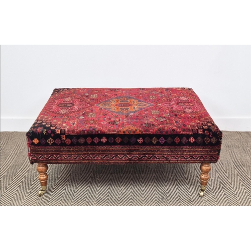 193 - HEARTH STOOL, rectangular red carpet upholstered on beech legs and brass castors, 43cm H x 105cm W x... 